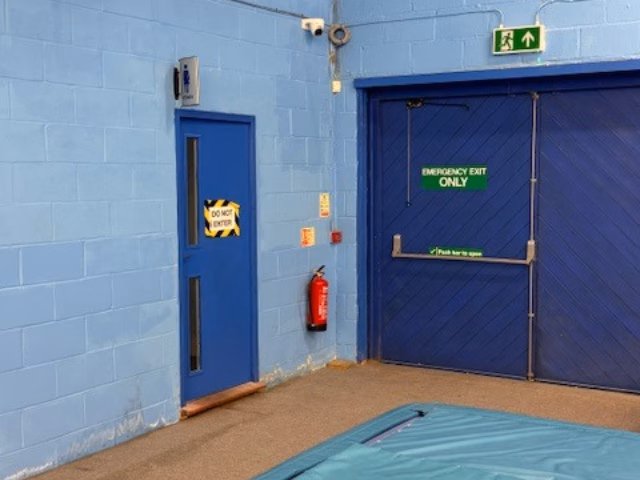 Dome camera above the emergency exit doors in the training hall