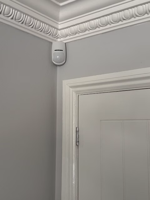 A PIR sensor in the corner of a room